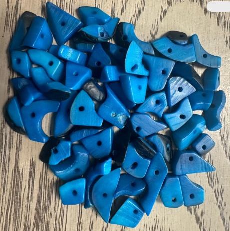 Mini tagua nuts, 100 pieces on blue beads. Size: approximately 1-2 cm. Center hole. Ideal for eco-friendly jewelry making. TBTBlue02