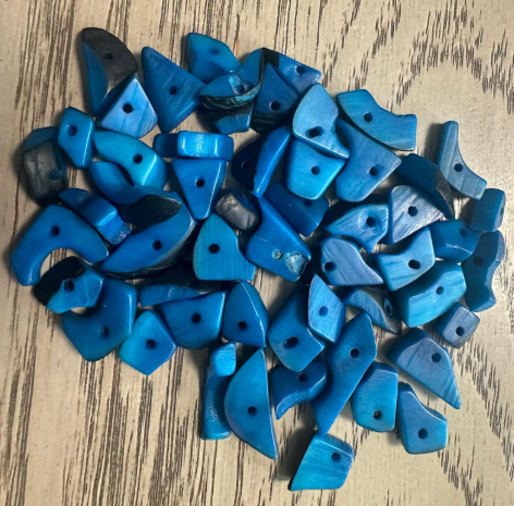 Mini tagua nuts, 100 pieces on blue beads. Size: approximately 1-2 cm. Center hole. Ideal for eco-friendly jewelry making. TBTBlue02