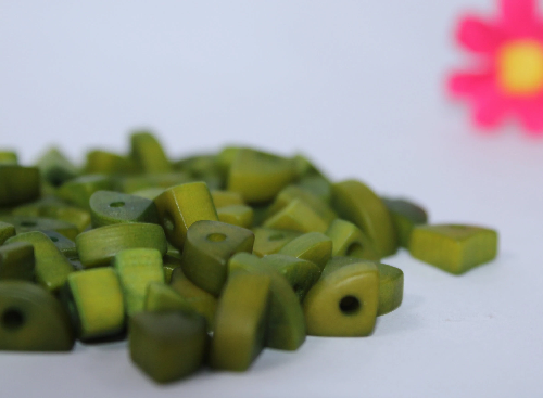 Mini tagua nuts in the shape of triangles. Green color. 100 pieces. Approx. 1cm x 0.7mm. Perforated in the center. Jewelry making TBTGreen02