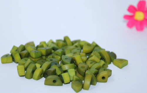 Mini tagua nuts in the shape of triangles. Green color. 100 pieces. Approx. 1cm x 0.7mm. Perforated in the center. Jewelry making TBTGreen02