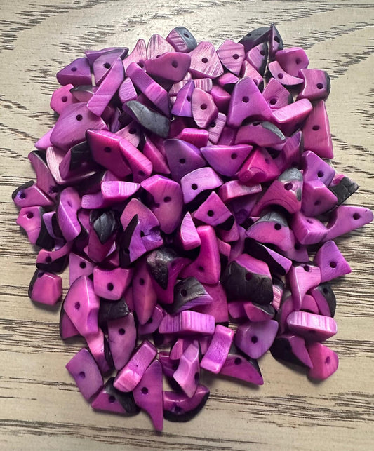 Mini tagua nuts, 100 pieces on Lilac beads. Size: approximately 1-2 cm. Center hole. Ideal for eco-friendly jewelry making. TBTLilac01