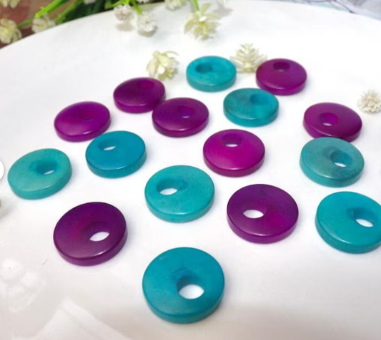 Tagua Beads Donut Shape. Tagua Discs in 2 colors. 16 Tagua Beads. 0.7 in. Height x 0.7 in. Width. Handmade from Colombia. Jewerly Supplies