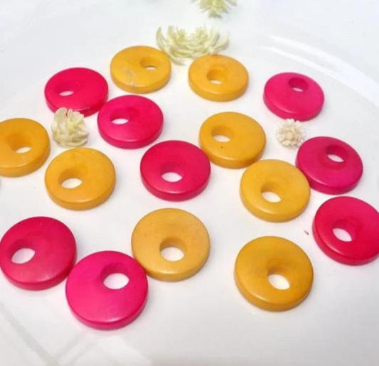 Tagua Beads Donut Shape. Tagua Discs in 2 colors. 16 Tagua Beads. 0.7 in. Height x 0.7 in. Width. Handmade from Colombia. Jewerly Supplies