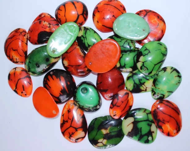 Green and orange Tagua Oval Beads. Natural Seed from Colombia. 44 beads: 18 beads in green and 26 beads in orange. 1,1 x 0,7in Approx.